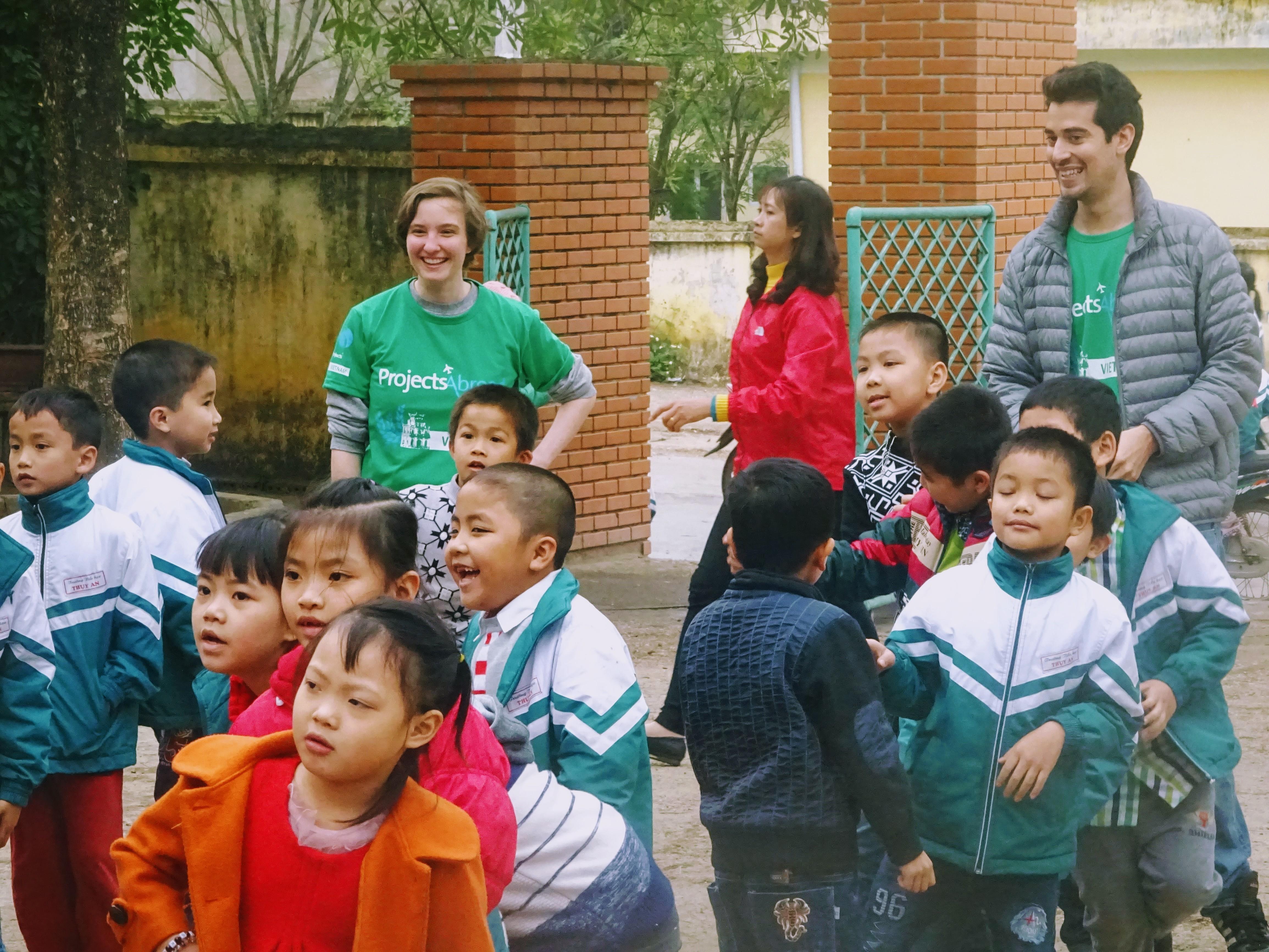 Projects Abroad volunteers play an educational game with children outside a care centre in Vietnam. Volunteers play with a group of children outside a care centre at their Childcare placement in Vietnam.